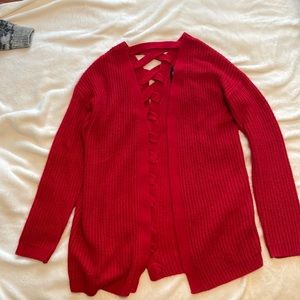 A long, red cardigan. Made by derek heart.